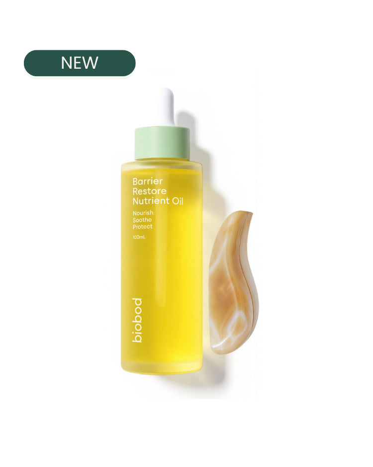 Yellow bottle of Barrier Restore Nutrient Oil with a green cap on a white background