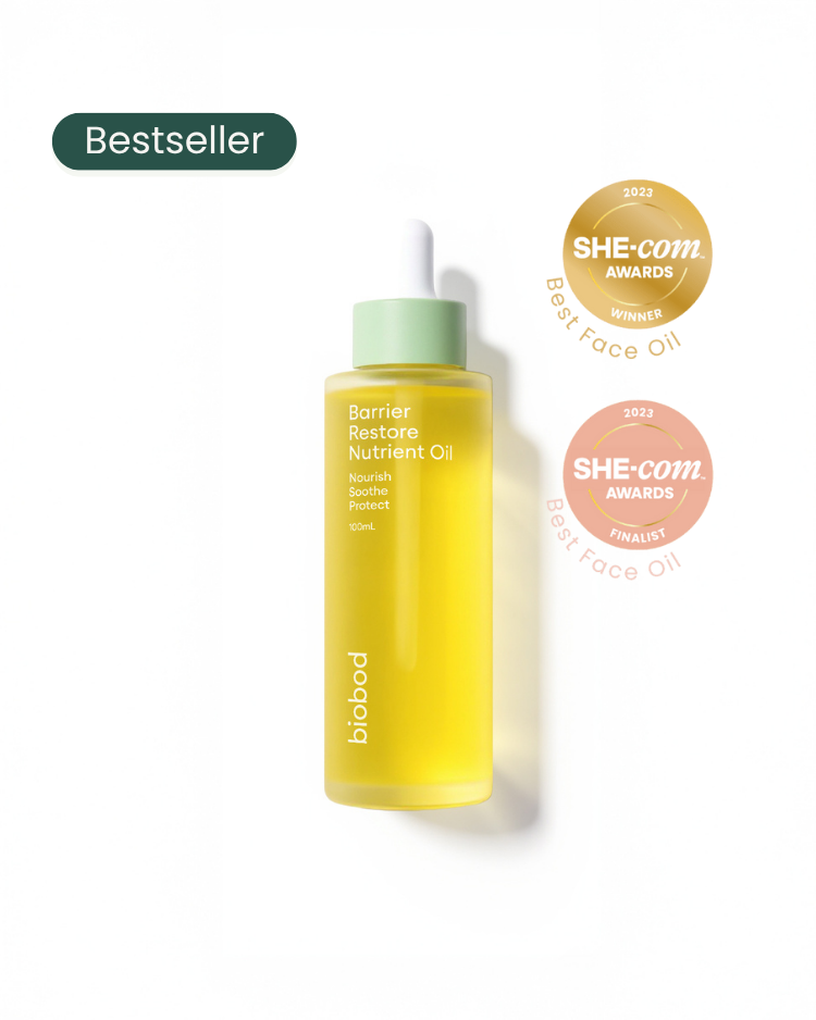 Yellow bottle of skincare oil for sensitive skin with green cap on a white background, featuring awards logos.