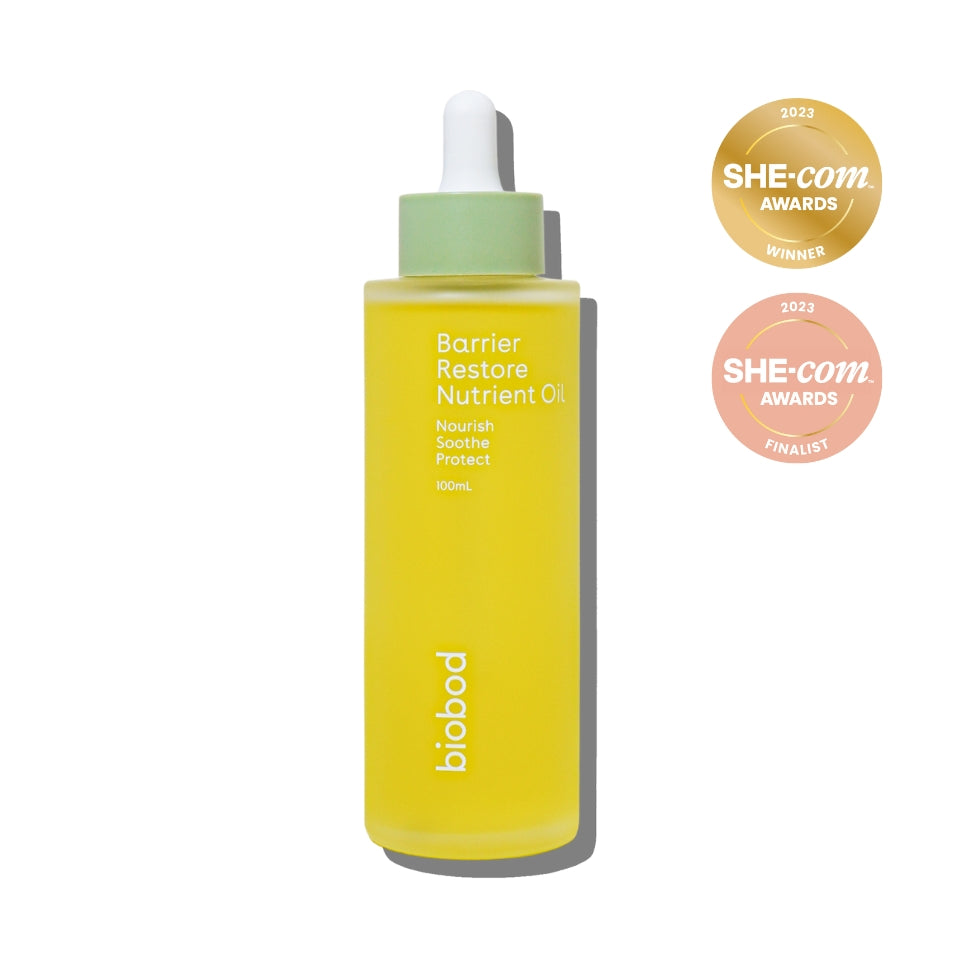 Yellow bottle of Barrier Restore Nutrient Oil with dropper on a white background, featuring SHE-com Awards badges.