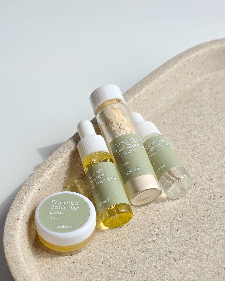 sensitive skincare product samples on a stone surface with a light background