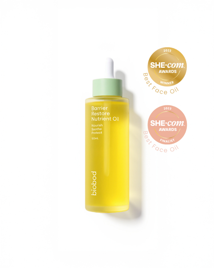 Yellow bottle of skincare oil for sensitive skin with green cap on a white background, featuring awards logos.