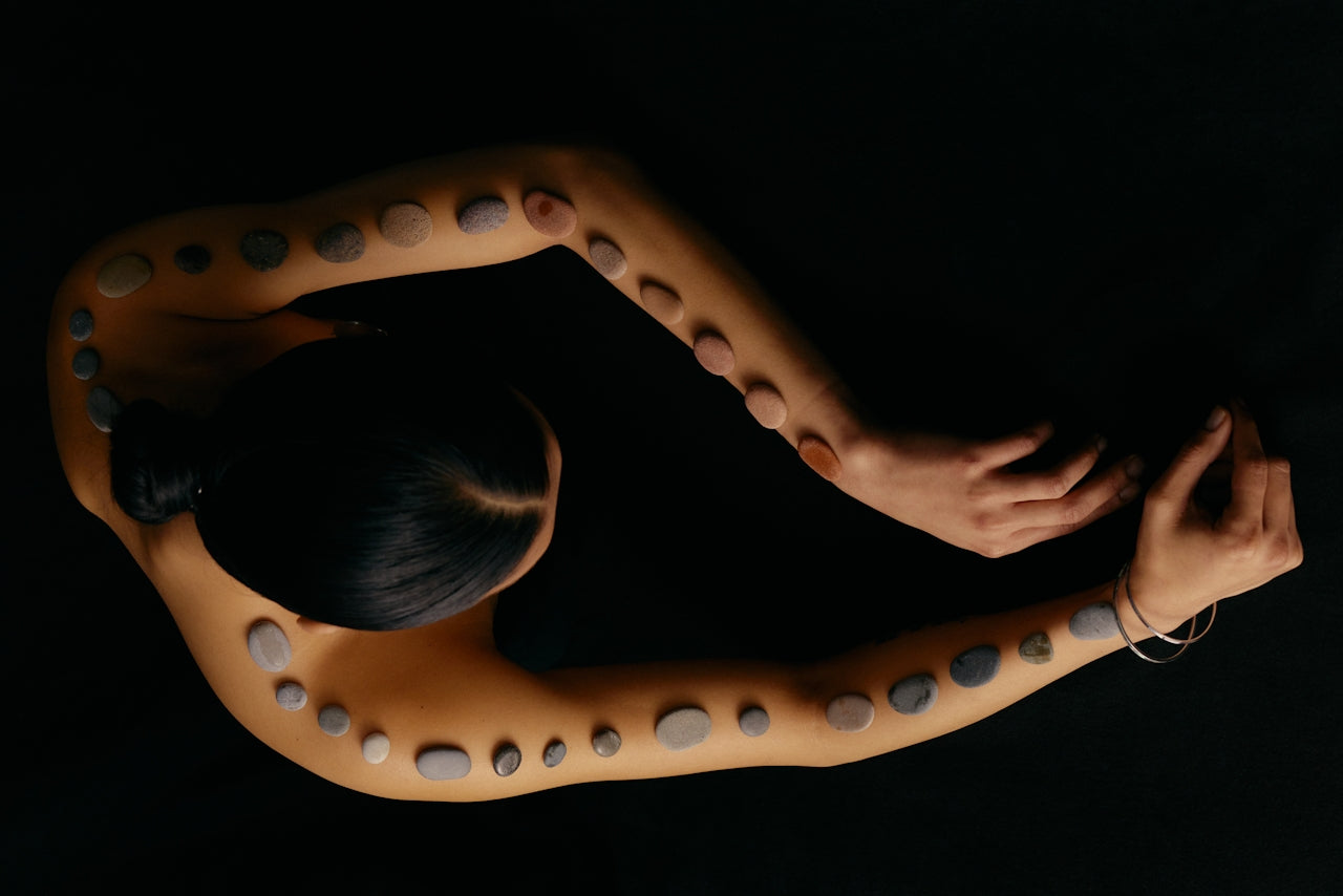 Person lying on a acupressure mat with a dark background